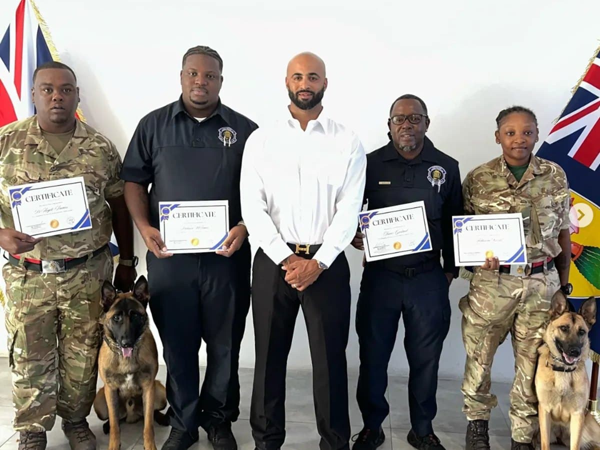 Jas Leverette with Turks and Caicos military K-9 handlers holding their training certificates